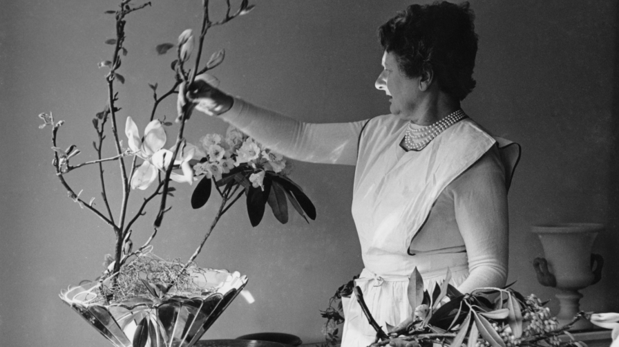Black and white image of Constance Spry arranging flowers