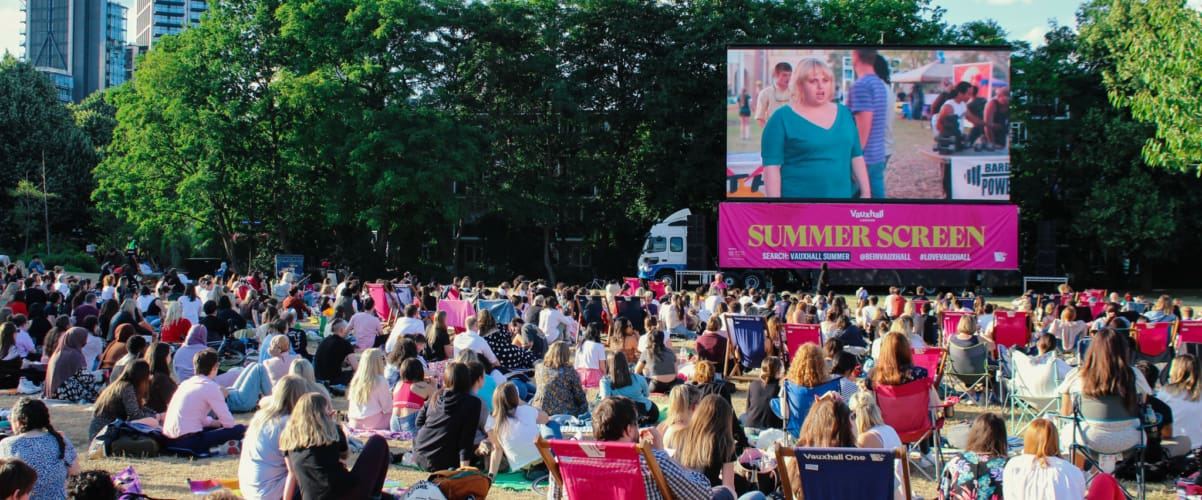 A crowd of people enjoying an outdoor screening of a film during Vauxhall Summer Season 2022