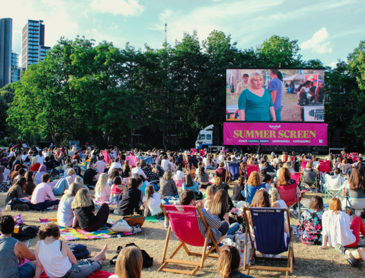A crowd of people enjoying an outdoor screening of a film during Vauxhall Summer Season 2022